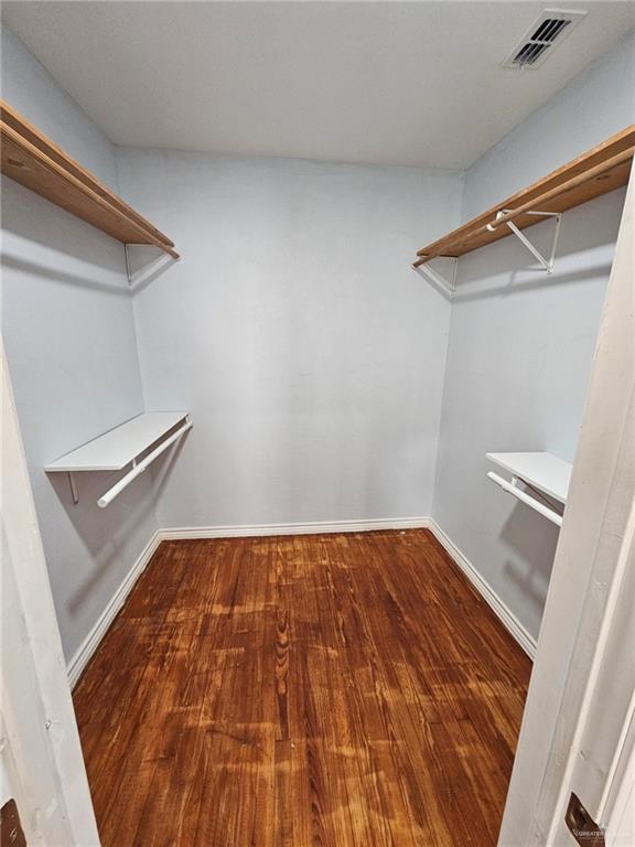 walk in closet featuring hardwood / wood-style floors