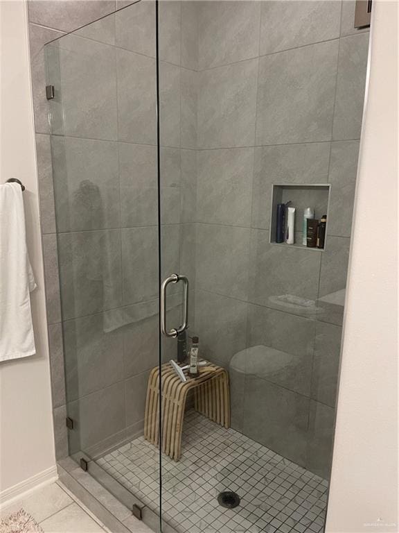 8507 N 33rd Ln N, Mcallen, TX 78504 - full bathroom featuring a shower stall, tile patterned floors, and baseboards