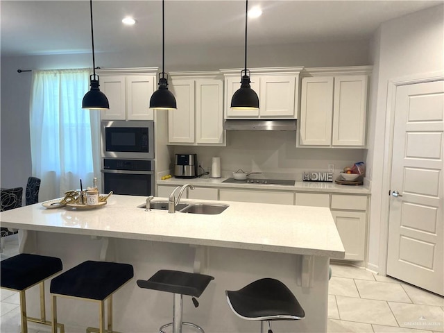 8507 N 33rd Ln N, Mcallen, TX 78504 - kitchen with stainless steel oven, built in microwave, a sink, and a breakfast bar area
