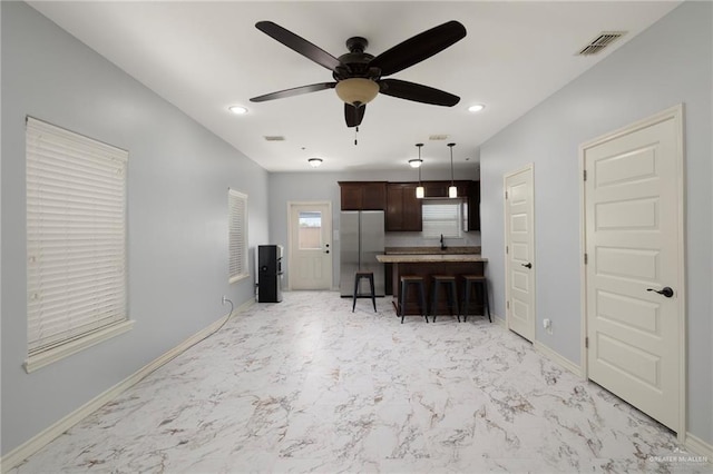 1200 E Pineridge Ave Unit 1, Mcallen, TX 78503 - living room featuring ceiling fan, light marble finish flooring, baseboards, and recessed lighting
