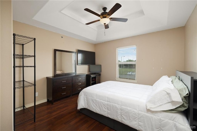 1200 E Pineridge Ave Unit 1, Mcallen, TX 78503 - bedroom featuring a tray ceiling, dark wood finished floors, baseboards, and a ceiling fan