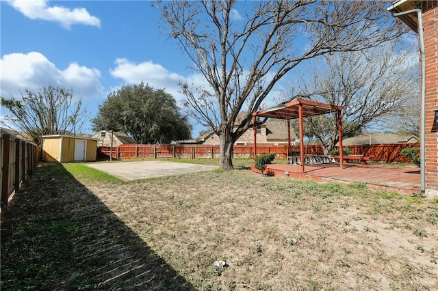 view of yard featuring a wooden deck and a storage shed