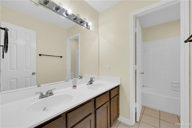 bathroom featuring vanity, tiled shower / bath, and tile patterned floors