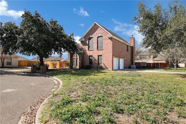 front of property with a front lawn and a garage