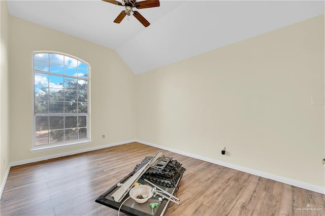 unfurnished room with hardwood / wood-style floors, lofted ceiling, and ceiling fan