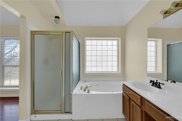 bathroom with vanity and shower with separate bathtub