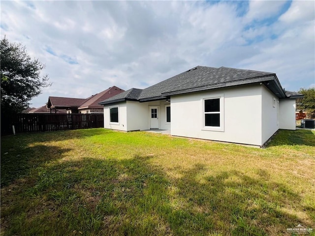 rear view of house featuring a yard