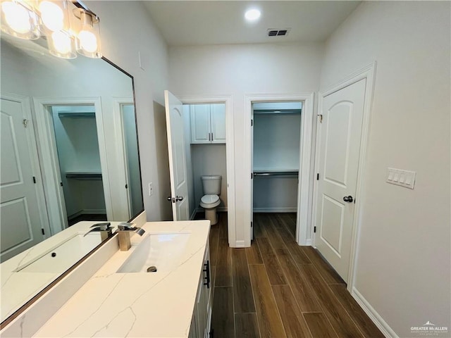 bathroom featuring toilet and vanity