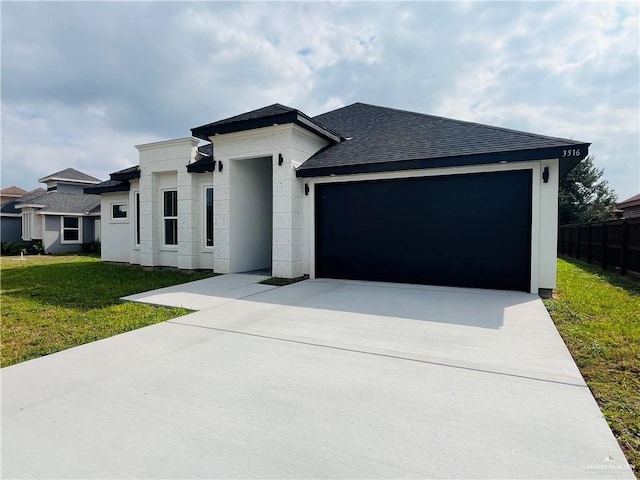 view of front of home with a garage and a front yard