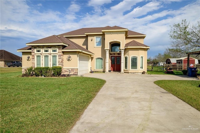 mediterranean / spanish house featuring a garage and a front lawn