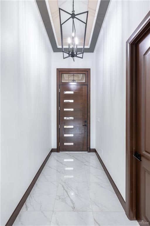 doorway with a notable chandelier