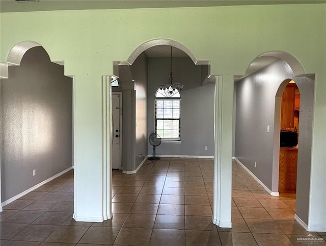 205 Msg Mario A Solis Ln, La Villa, TX 78562 - unfurnished room featuring dark tile patterned floors, a chandelier, and arched walkways