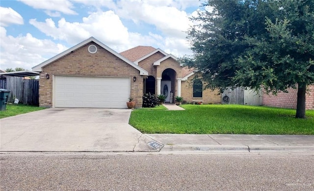 205 Msg Mario A Solis Ln, La Villa, TX 78562 - view of front of house featuring brick siding, driveway, and an attached garage