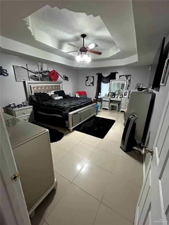 205 Msg Mario A Solis Ln, La Villa, TX 78562 - bedroom with a raised ceiling, tile patterned flooring, and a ceiling fan