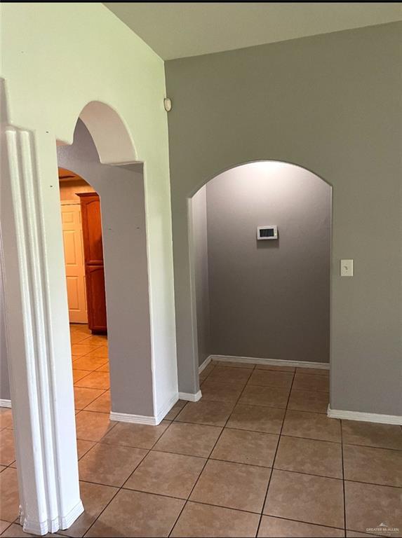 205 Msg Mario A Solis Ln, La Villa, TX 78562 - hallway with light tile patterned floors, arched walkways, and a high ceiling