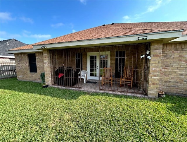 205 Msg Mario A Solis Ln, La Villa, TX 78562 - back of property with brick siding, roof with shingles, and a patio area