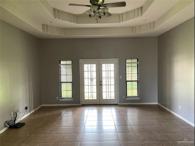 205 Msg Mario A Solis Ln, La Villa, TX 78562 - tiled empty room featuring a ceiling fan, french doors, a high ceiling, and a raised ceiling