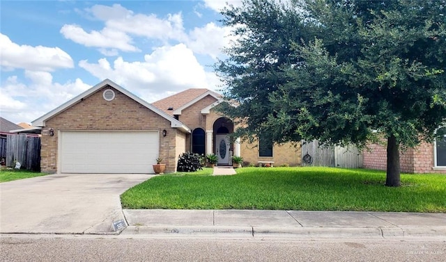 205 Msg Mario A Solis Ln, La Villa, TX 78562 - view of front of property featuring brick siding, concrete driveway, and an attached garage