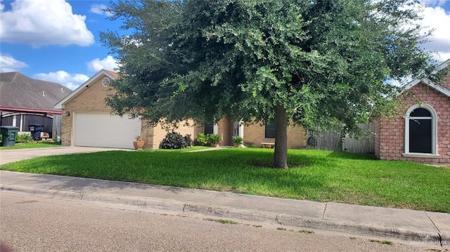 205 Msg Mario A Solis Ln, La Villa, TX 78562 - obstructed view of property featuring driveway, an attached garage, a front yard, and brick siding