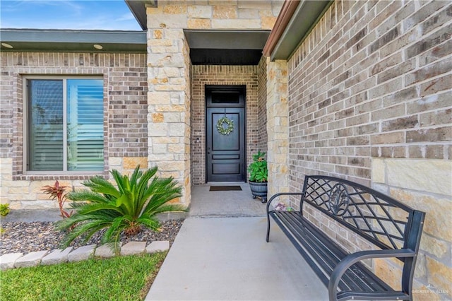 property entrance featuring brick siding