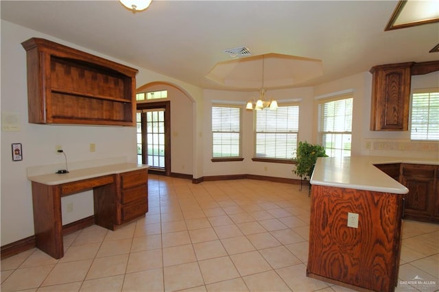 kitchen featuring a center island, decorative light fixtures, light tile patterned flooring, and a chandelier