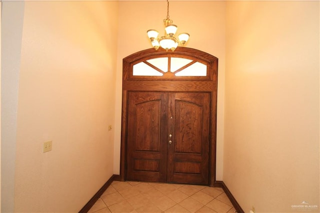 entrance foyer featuring light tile patterned floors and a chandelier