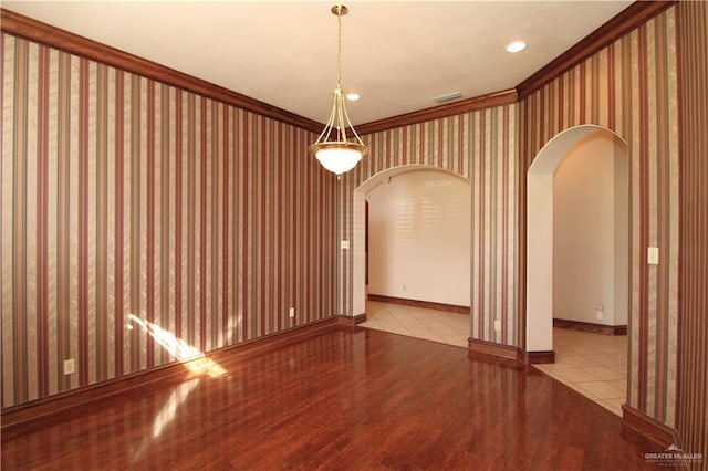 unfurnished room featuring light hardwood / wood-style floors and crown molding