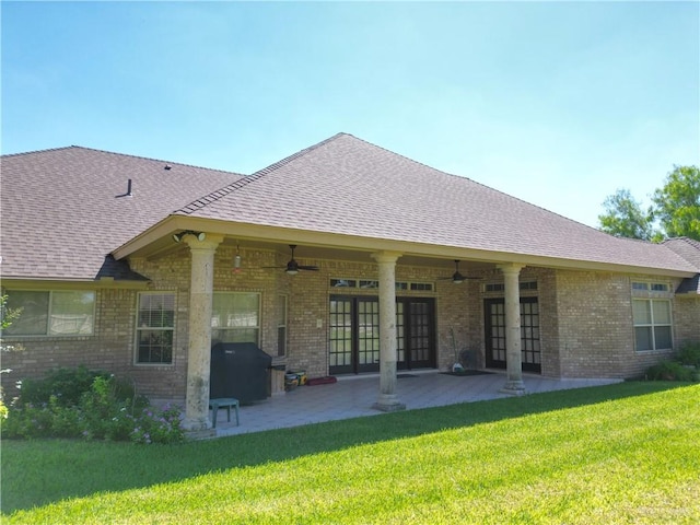 rear view of property featuring a lawn, ceiling fan, and a patio