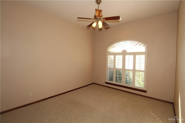 carpeted spare room with ceiling fan