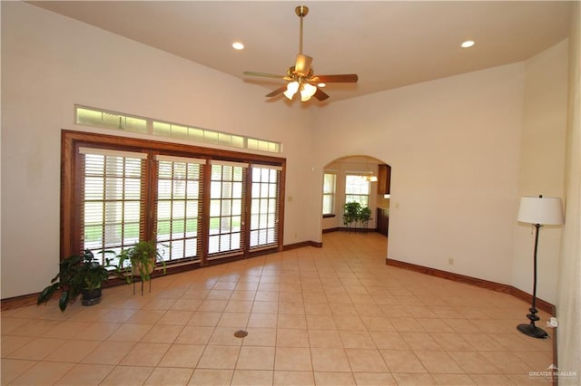 unfurnished room with ceiling fan and light tile patterned floors