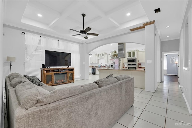 living room with coffered ceiling, light tile patterned floors, beam ceiling, and ceiling fan