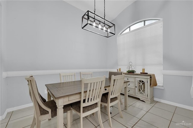 tiled dining area featuring lofted ceiling