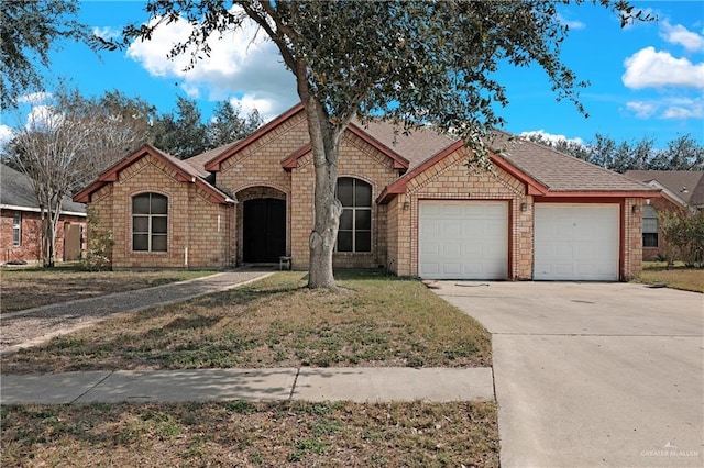 view of front of property featuring a garage and a front yard