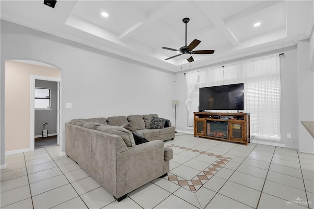 living room with beamed ceiling, coffered ceiling, light tile patterned floors, and ceiling fan