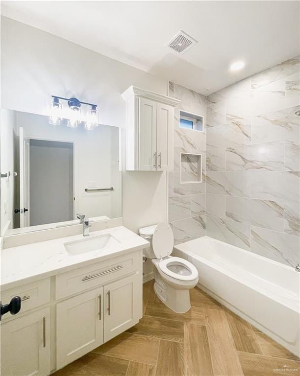 full bathroom with vanity, toilet, and tiled shower / bath