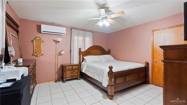 bedroom featuring a wall unit AC, ceiling fan, light tile patterned floors, and baseboards