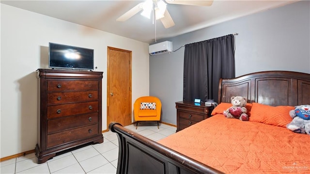 bedroom with an AC wall unit, light tile patterned flooring, a ceiling fan, and baseboards