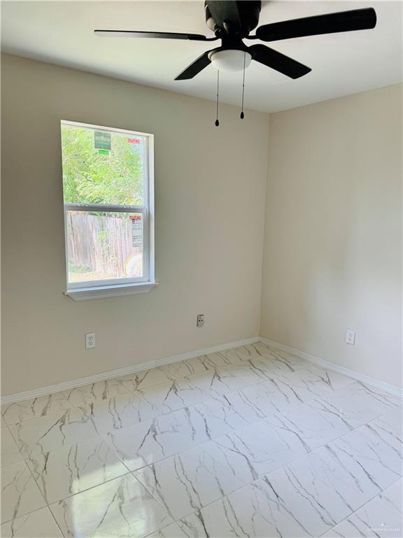 314 W Lincoln Ave, Harlingen, TX 78550 - unfurnished room featuring a ceiling fan and marble finish floors
