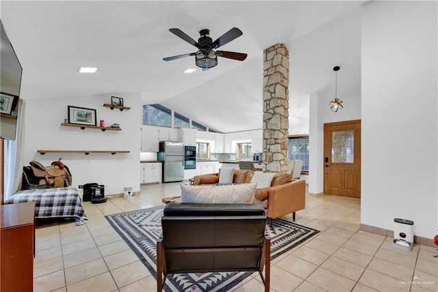 tiled living room featuring ceiling fan and high vaulted ceiling