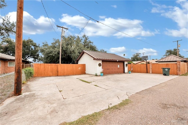 view of property exterior featuring a garage and an outdoor structure