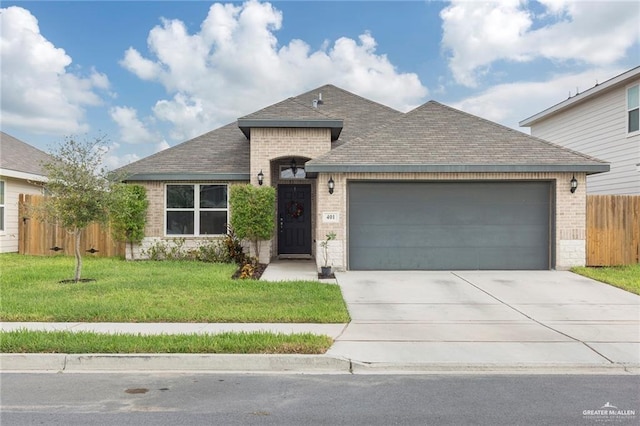 view of front of home with concrete driveway, an attached garage, fence, a front lawn, and brick siding