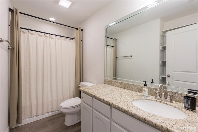 full bathroom with toilet, a shower with curtain, wood finished floors, vanity, and recessed lighting