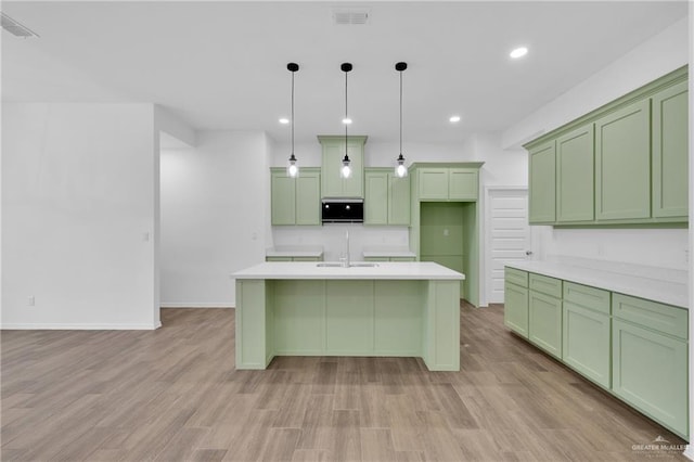 kitchen with light countertops, hanging light fixtures, visible vents, and green cabinetry