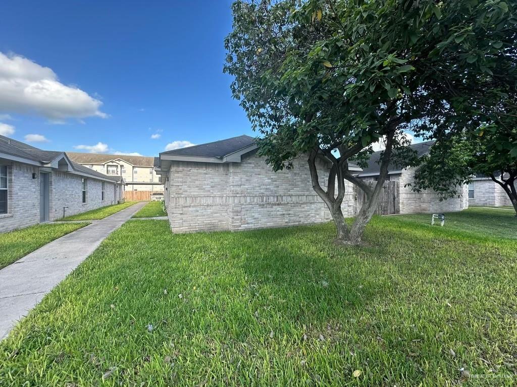 view of property exterior with a yard