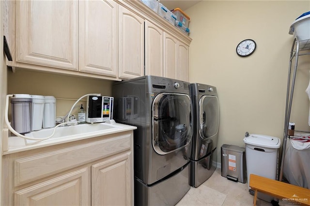 16408 Garrett Rd, Harlingen, TX 78552 - washroom with washer and clothes dryer, cabinet space, and light tile patterned flooring