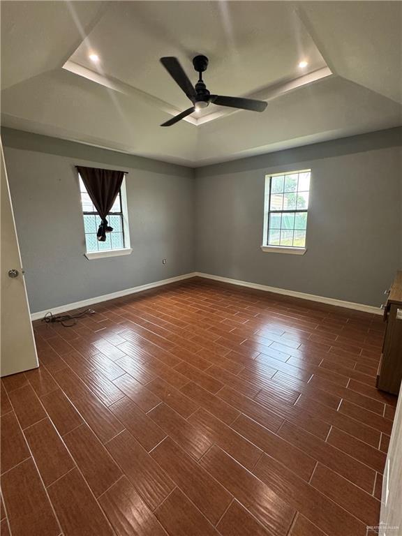 2110 Tiffany Dr, Mission, TX 78574 - unfurnished room featuring a raised ceiling, ceiling fan, baseboards, dark wood-type flooring, and recessed lighting