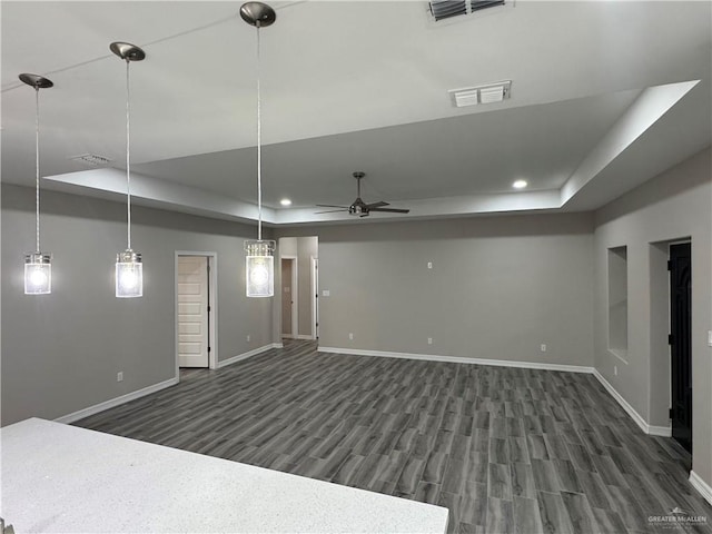 basement featuring ceiling fan and dark hardwood / wood-style floors