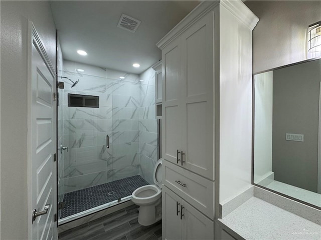 bathroom featuring vanity, wood-type flooring, toilet, and walk in shower