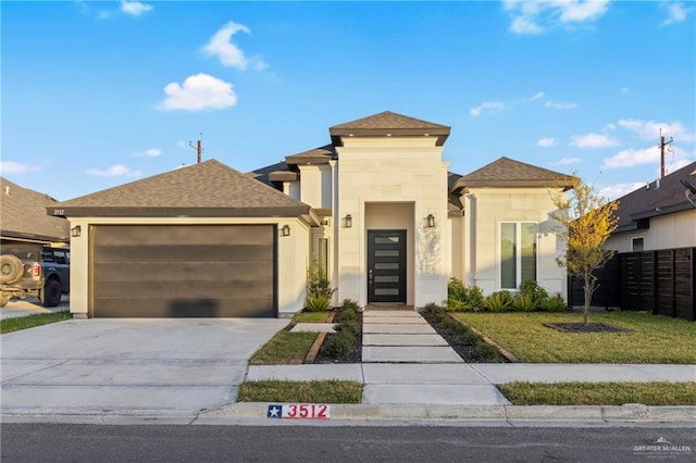 view of front of house with a front yard and a garage