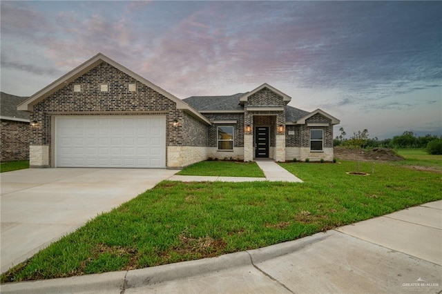 view of front facade with a garage and a yard